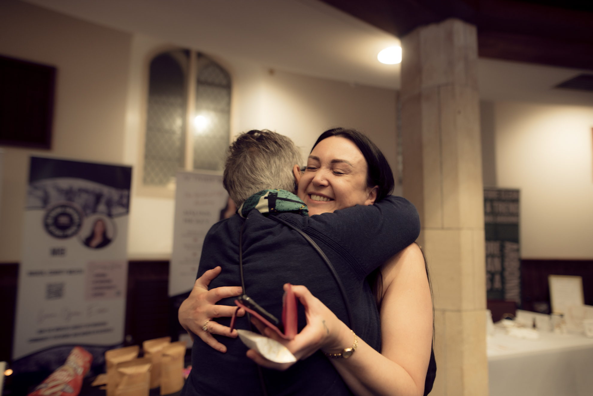 A warm embrace between two attendees